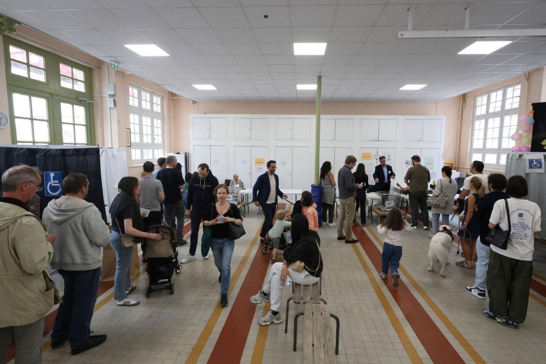 People queue to vote during the second round of the legislative elections, Sunday, July 7, 2024 in Paris. France votes Sunday in pivotal runoff elections that could hand a historic victory to Marine Le Pen's far-right National Rally and its inward-looking, anti-immigrant vision — or produce a hung parliament and years of political deadlock. (AP Photo/Aurelien Morissard)