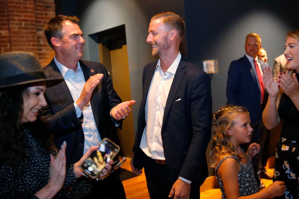 Ryan Walters, right, stands beside Gov. Kevin Stitt after winning the GOP primary runoff election for state superintendent at a watch party in Oklahoma City on Tuesday. Walters ran a campaign emphasizing social issues and eliminating "woke ideology" from schools.