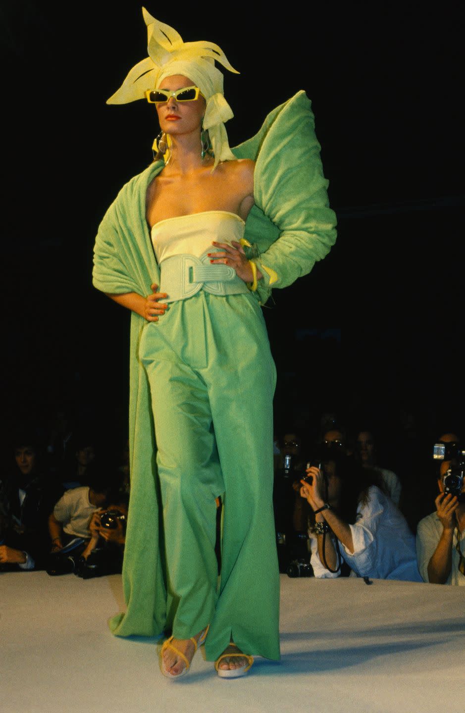 <p>A model in an all-green look and matching sunglasses walks the Claude Montana runway at Paris Fashion Week. </p>