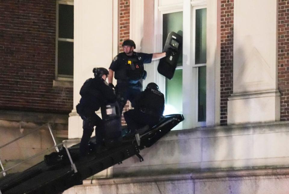 New York City police officers use a ramp on an armored vehicle to enter Hamilton Hall at Columbia University. STEPHANI SPINDEL/EPA-EFE/Shutterstock