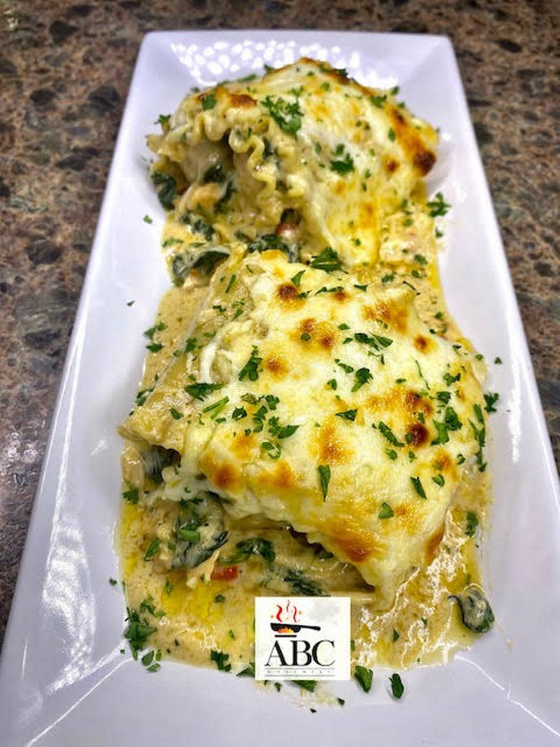 Tuscan chicken lasagna with a homemade Alfredo sauce from ABC Catering LLC food truck.