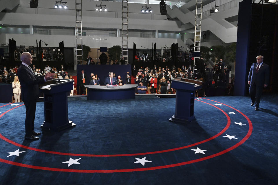 Democratic presidential candidate former Vice President Joe Biden gestures as President Donald Trump walks onto stage for the first presidential debate Tuesday, Sept. 29, 2020, at Case Western University and Cleveland Clinic, in Cleveland. (Olivier Douliery/Pool vi AP)