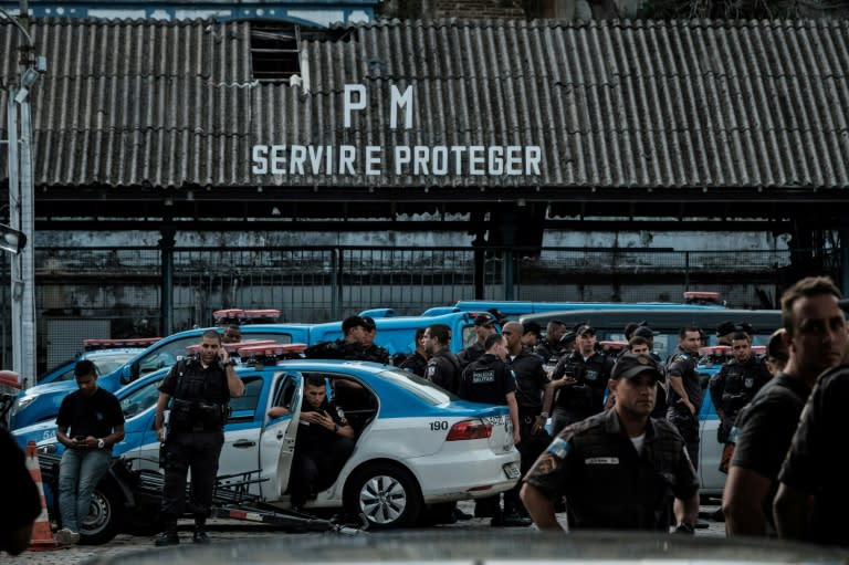 Military police officers wait as their relatives block the entrance to the military police station during a protest for better salaries and working conditions in Rio de Janeiro, Brazil, on February 10, 2017