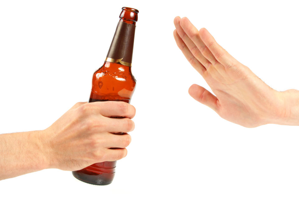 hand reject a bottle of beer. isolated on white background