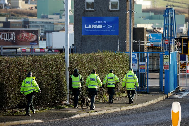 FILE PHOTO: Police officers carry out a security sweep near the Port of Larne