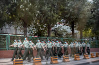 Chinese paramilitary police march in formation outside the Xinfadi wholesale food market district in Beijing, Saturday, June 13, 2020. Beijing closed the city's largest wholesale food market Saturday after the discovery of seven cases of the new coronavirus in the previous two days. (AP Photo/Mark Schiefelbein)