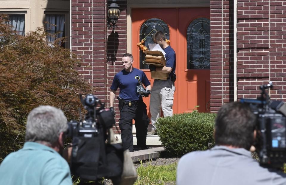 FBI agents carry materials from the home of UAW President Gary Jones during a search of his Canton home on Wednesday, August 28, 2019. (Max Ortiz/Detroit News via AP)