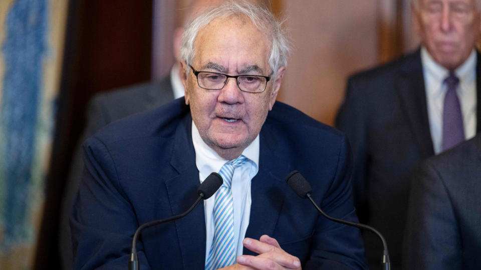 Former Congressman Barney Frank speaks at a podium.