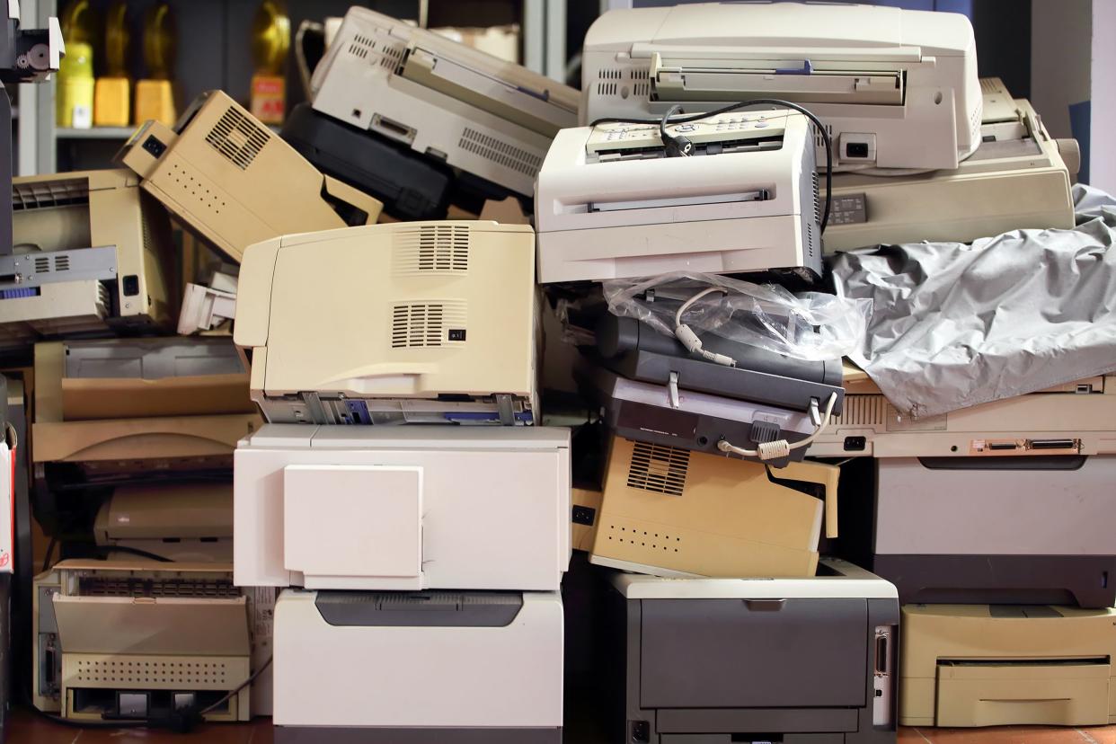 stack of disused computer printers to be scrapped or recycled