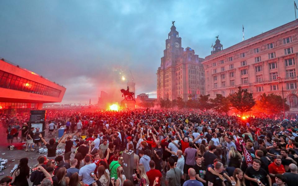 Fans are being urged to celebrate the clubs Premier League triumph at home as police believe more gatherings are planned after thousands filled the streets outside Anfield - Peter Byrne/PA Wire