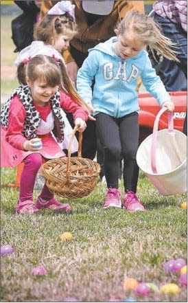 Willow Grant (left) and Jackie Hawrylak search for eggs in a previous Flat Rock Easter egg hunt.