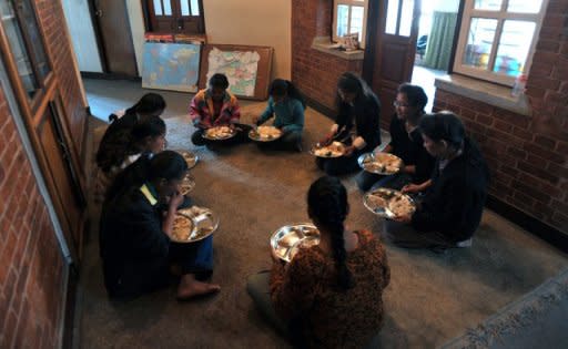 Nepalese Humla children are seen having lunch at their home in Kathmandu. While their classmates come from the country's wealthiest elite, these children were rescued seven years ago, dirty and sick, from a cowshed on the edge of the capital