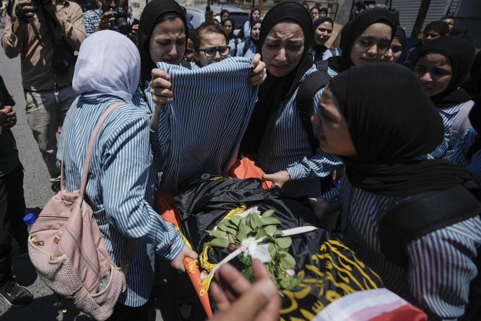 The classmates of 15-year-old Sadeel Naghniyeh carry her body during her funeral in the West Bank Jenin refugee camp, Wednesday, June 21, 2023, Naghniyeh died from wounds sustained in an Israeli military raid on Monday that triggered some of the fiercest fighting with Palestinian militants in years. (AP Photo/Majdi Mohammed)