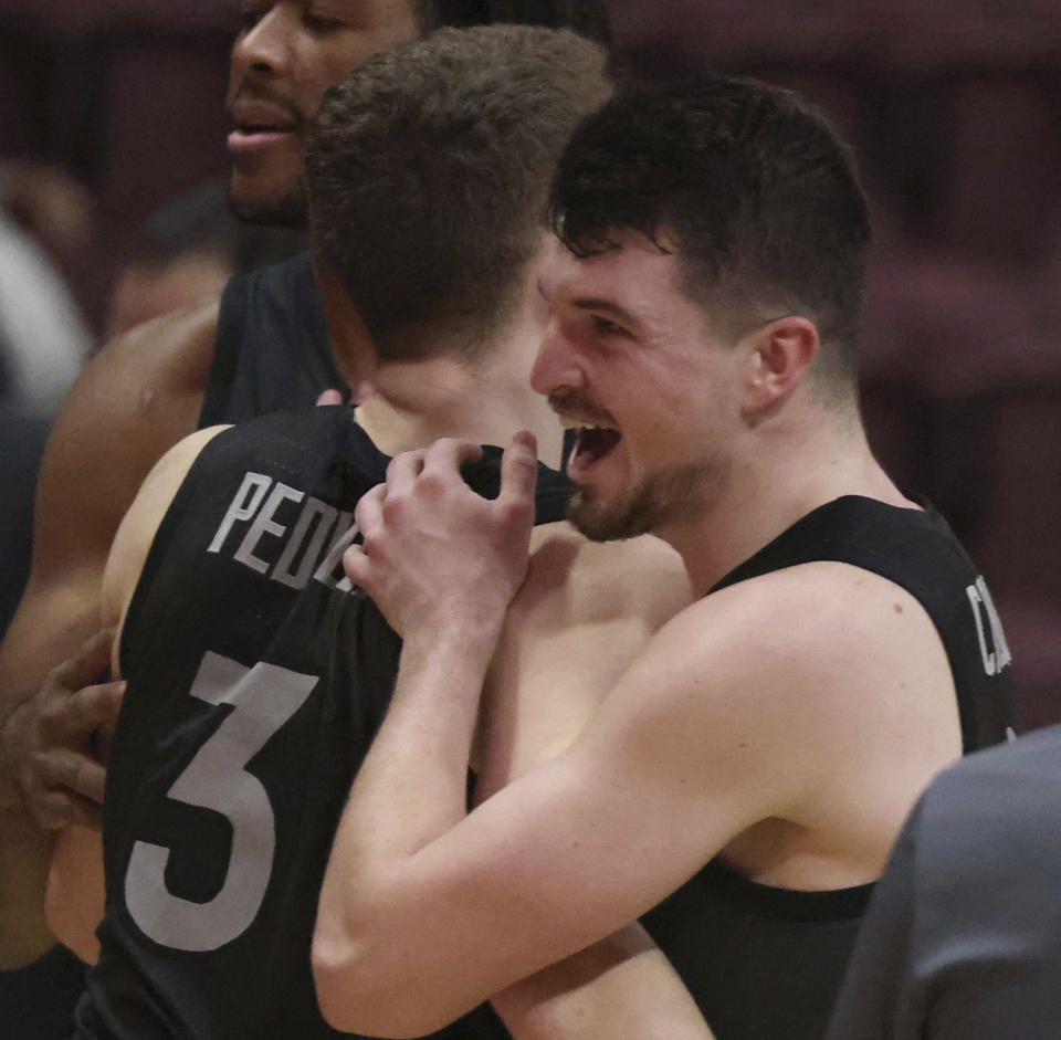 Virginia Tech's Sean Pedulla (3) and Hunter Cattoor (0) celebrate the team's win over Boston College in NCAA college basketball game Tuesday, Jan. 23, 2024, in Blacksburg, Va. (Matt Gentry/The Roanoke Times via AP)