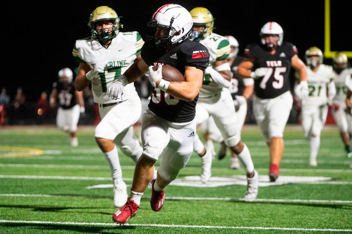 Yelm running back William Carreto breaks away from Timberline’s secondary for a large rushing gain during the first quarter of a 3A SSC game on Thursday, Oct. 13, 2022, at Yelm High School in Yelm, Wash.