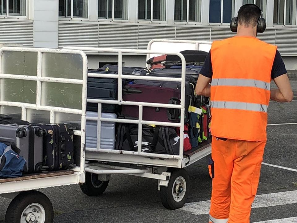 A baggage handler loads luggage into a plane (Simon Calder)