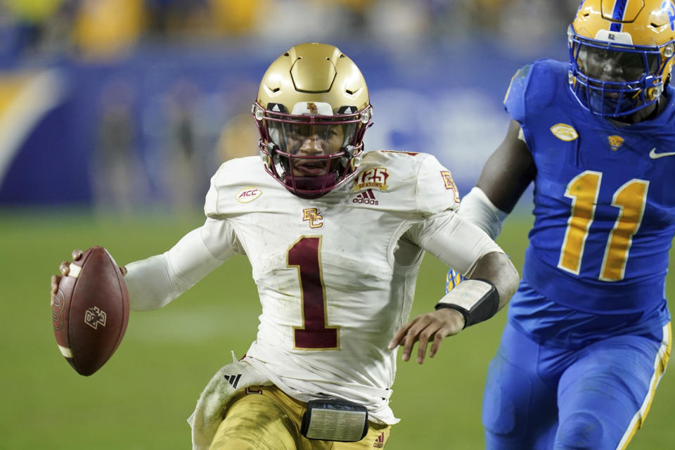 Boston College quarterback Thomas Castellanos (1) carries for a first down in front of Pittsburgh linebacker Bangally Kamara (11) during the second half of an NCAA college football game, Thursday, Nov. 16, 2023, in Pittsburgh. (AP Photo/Matt Freed)