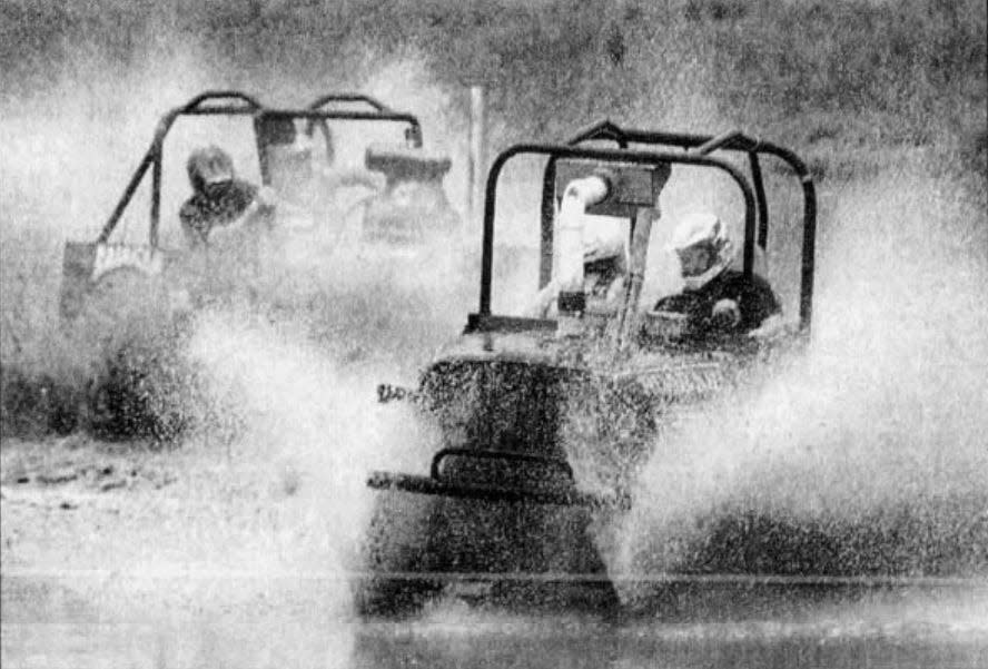 Shawn Ives drives Road Kill through the figure-8 track and wins his heat in the Coca-Cola championship swamp buggy races at Mesa Park in Fellsmere, Florida, Sunday, July 4, 1999.