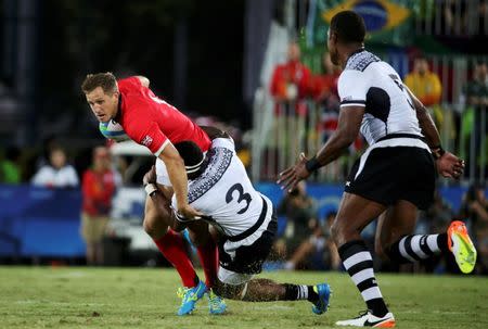 2016 Rio Olympics - Rugby - Men's Gold Medal Match - Fiji v Great Britain - Deodoro Stadium - Rio de Janeiro, Brazil - 11/08/2016. Mark Robertson (GBR) of Great Britain is tackled by Semi Kunatani (FIJ) of Fiji. REUTERS/Alessandro Bianch