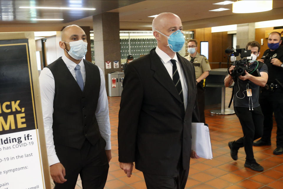 Former Minneapolis Police Officer J. Alexander Kueng, left, enters the Hennepin County Government Center in Minneapolis Tuesday, July 21, 2020, with his attorney Thomas Plunkett, right, for a hearing. Kueng is one of four officers, who were fired after George Floyd’s May 25 death. (AP Photo/Jim Mone)