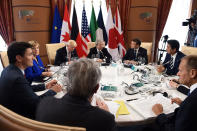 <p>G7 Summit members attend the first working session, with from bottom C, President of the European Commission President Jean-Claude Juncker, Canadian Prime Minister Justin Trudeau, German Chancellor Angela Merkel, U.S. President Donald Trump, Italian Prime Minister Paolo Gentiloni, President of France Emmanuel Macron, Japan’s Prime Minister Shinzo Abe, Britain’s Prime Minister Theresa May (hidden) and President of the European Council Donald Tusk, in Taormina in Sicily, Italy, May 26, 2017. (Photo: Eliot Blondet/Pool/Reuters) </p>