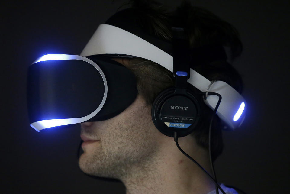 Marcus Ingvarsson tests out the PlayStation 4 virtual reality headset Project Morpheus in a demo area at the Game Developers Conference 2014 in San Francisco, Wednesday, March 19, 2014. (AP Photo/Jeff Chiu)