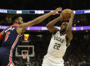 Milwaukee Bucks' Khris Middleton puts up a shot against Washington Wizards' Troy Brown Jr. during during the second half of an NBA basketball game Tuesday, Jan. 28. 2020, in Milwaukee. (AP Photo/Jeffrey Phelps)