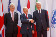 French Finance Minister Bruno Le Maire, right, welcomes German Finance Minister Olaf Scholz, center, with Governor of the Bank of France Francois Villeroy de Galhau, at the G-7 Finance Wednesday July 17, 2019.The top finance officials of the Group of Seven rich democracies are arriving at Chantilly, at the start of a two-day meeting aimed at finding common ground on how to tax technology companies and on the risk from new digital currencies. (AP Photo/Michel Euler)