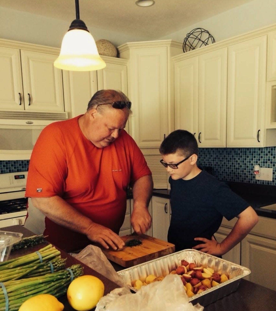 Kevin Cronin cooking in the kitchen at home with his nephew Joey Cronin.