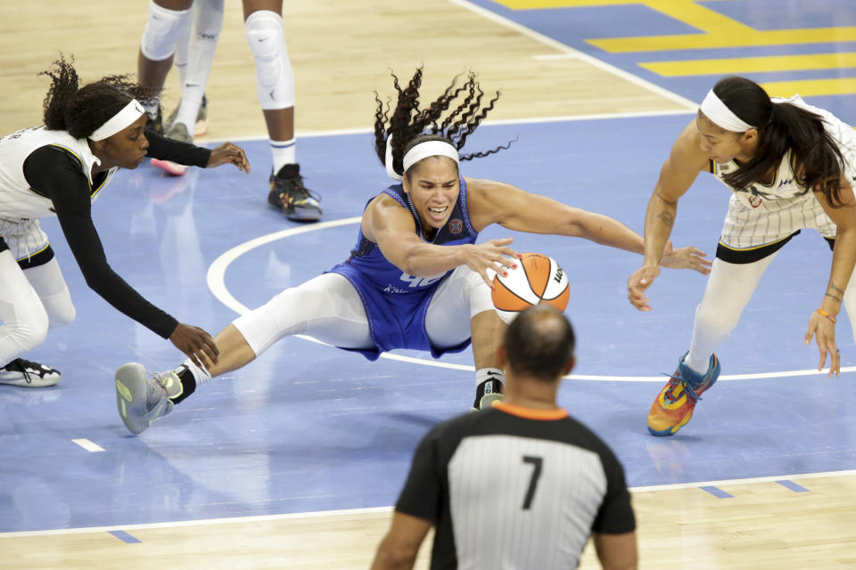 Connecticut Sun forward Brionna Jones, center, tries to protect the ball from Chicago Sky's Kahleah Copper, left, and Candace Parker, right, during a WNBA basketball game Saturday, June 19, 2021, in Chicago. (AP Photo/Eileen T. Meslar)