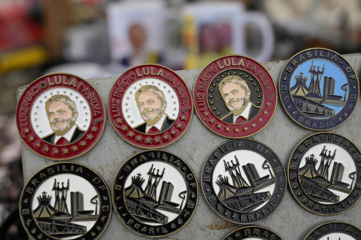Souvenir inaugural pins with the image of Brazilian President-elect Luiz Inacio Lula da Silva are displayed for sale in Brasilia, Brazil, Dec. 31, 2022, at the Esplanade of Ministries where his inauguration ceremony will take place on Jan. 1, 2023, as the country's new leader. (AP Photo/Eraldo Peres, File)