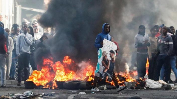 Residents of Masiphumelele set up burning barricades amidst an ongoing strike by taxi operators against traffic authorities in Cape Town, South Africa, August 8, 2023