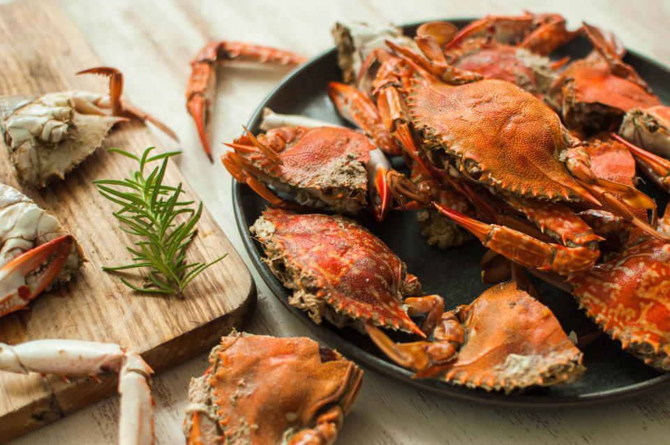 High angle view of boiled blue crabs on the plate and cutting board