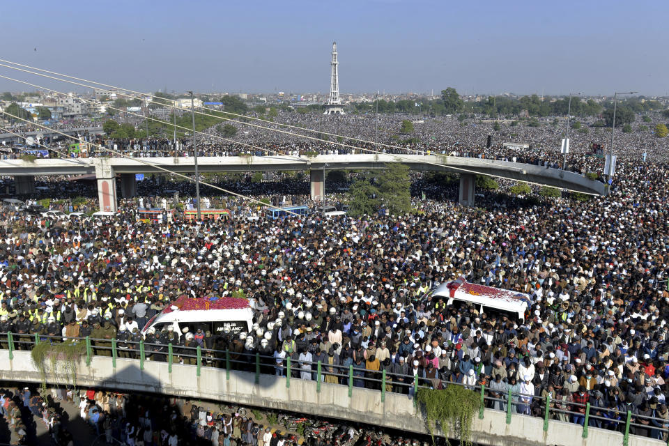 Mourners gather for the funeral prayer of Khadim Hussein Rizvi, an Islamist scholar and leader of Tehreek-e-Labiak Pakistan, in Lahore, Pakistan, Saturday, Nov. 21, 2020. Tens of thousands of mourners on Saturday thronged the funeral of the radical cleric whose Islamist party has defended Pakistan's controversial blasphemy law that calls for the death penalty for insulting Islam. (AP Photo/Waleed Ahmed)