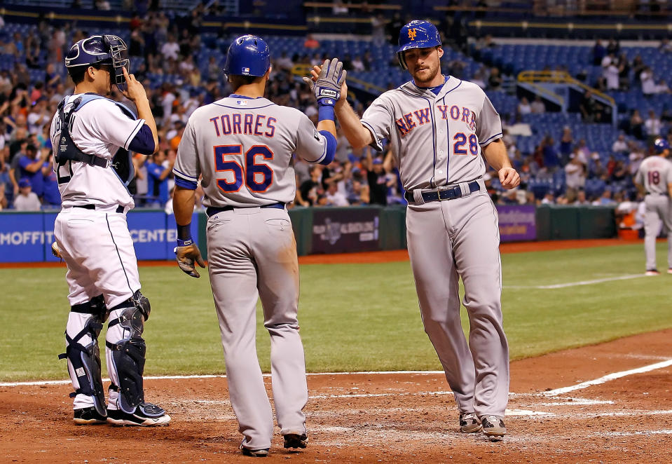 ST. PETERSBURG - JUNE 13: Infielder Daniel Murphy #28 of the New York Mets is congratulated by teammate Andres Torres #56 after scoring against the Tampa Bay Rays during the game at Tropicana Field on June 13, 2012 in St. Petersburg, Florida. (Photo by J. Meric/Getty Images)