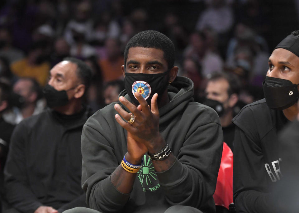 LOS ANGELES, CA - OCTOBER 03: Kyrie Irving #11 of the Brooklyn Nets cheers from the bench during a pre season game against the Los Angeles Lakers at Staples Center on October 3, 2021 in Los Angeles, California. NOTE TO USER: User expressly acknowledges and agrees that, by downloading and/or using this Photograph, user is consenting to the terms and conditions of the Getty Images License Agreement. (Photo by Kevork Djansezian/Getty Images)