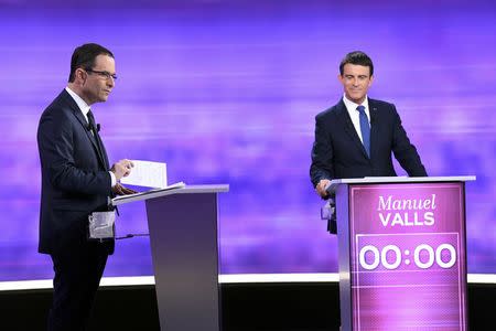 French Socialist party politicians, former prime minister Manuel Valls (R) and former education minister Benoit Hamon attend the final debate in the French left's presidential primary election in La Plaine-Saint-Denis, near Paris, France, January 25, 2017. REUTERS/Bertrand Guay/Pool