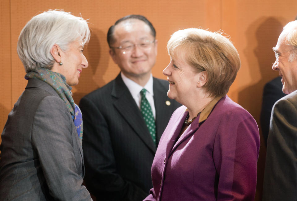 German chancellor, Angela Merkel, second right, welcomes International Monetary Fund (IMF) chief Christine Lagarde, left, while World Bank head Jim Yong Kim, center, looks on, in Berlin, Tuesday Oct. 30, 2012. (AP Photo / Kay Nietfeld , Pool)