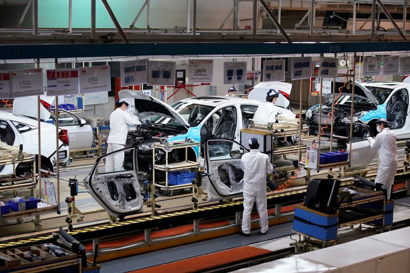 Employees work on a production line inside a Dongfeng Honda factory in Wuhan