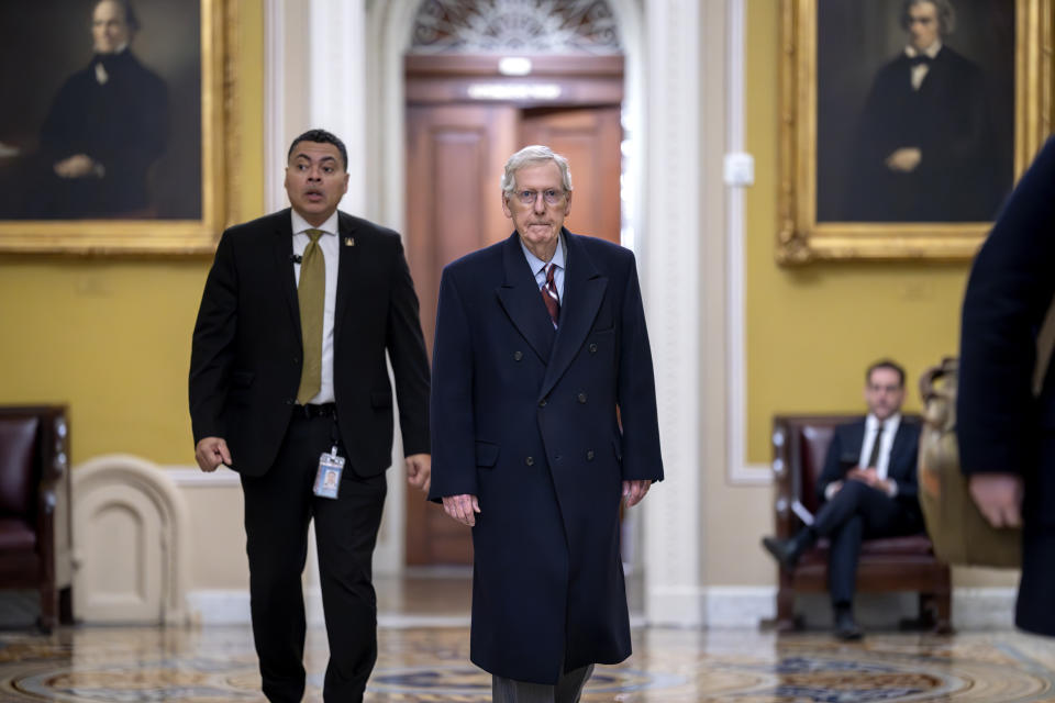 Senate Minority Leader Mitch McConnell, R-Ky., right, arrives as the Senate moves closer to a final vote on an emergency spending package that would provide military aid to Ukraine and Israel, replenish U.S. weapons systems and provide food, water and other humanitarian aid to civilians in Gaza, at the Capitol in Washington, Monday, Feb. 12, 2024. (AP Photo/J. Scott Applewhite)