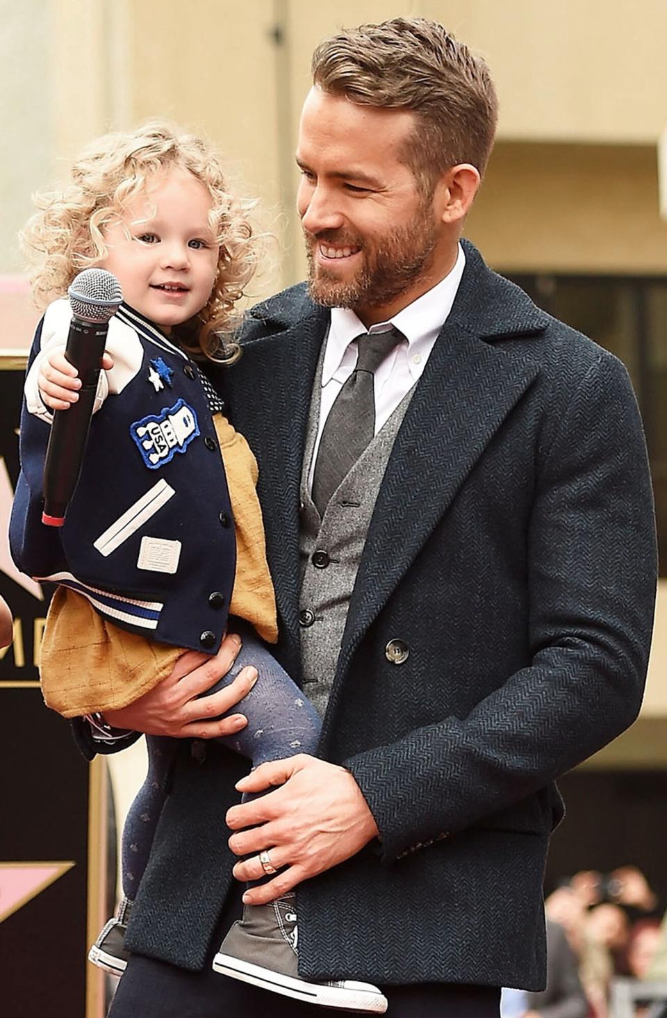 Ryan Reynolds (R) poses for a photo with his daughter, James Reynolds during a ceremony honoring him with a star on the Hollywood Walk of Fame on December 15, 2016 in Hollywood, California