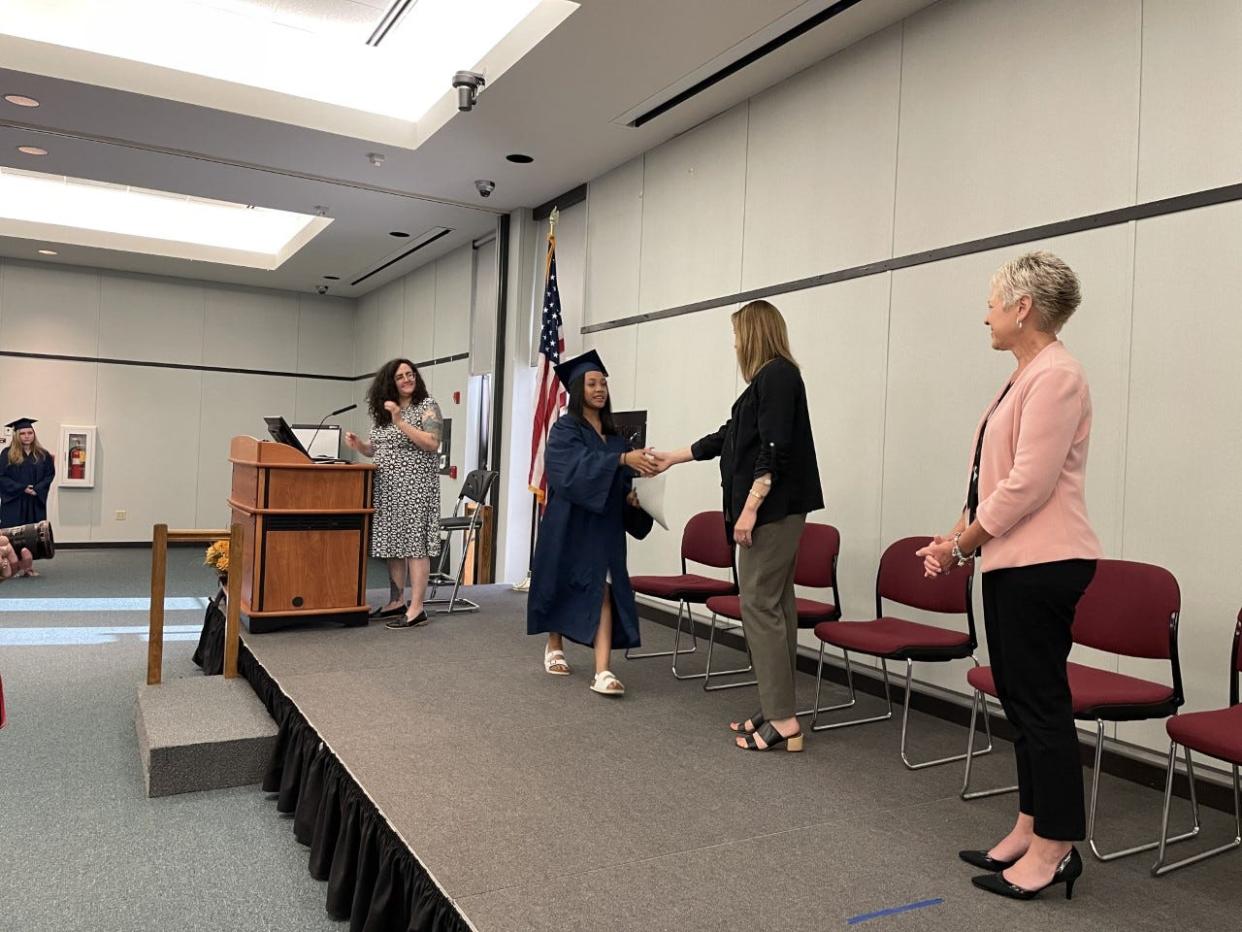 Abigail Manus accepts her GED certificate on Thursday, June 16, 2022, at Highland Community College in Freeport.