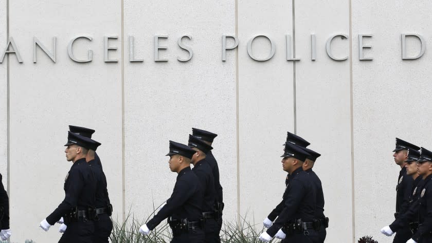An LAPD recruit officer class marches in for inspection during graduation exercises in the plaza of the downtown LAPD headquarters building. An audit has found no reliable way to track an extended-injury leave program, which costs the city millions of dollars.