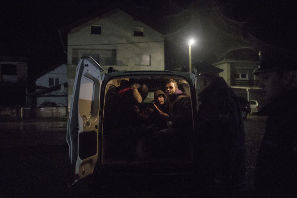 A group of Pakistani migrants sit cramped inside a small van after being taken off a train bound to the town of Bihac by Bosnian police in Bosanska Krupa, northwestern Bosnia on Dec. 14, 2019. (Photo: Manu Brabo/AP)