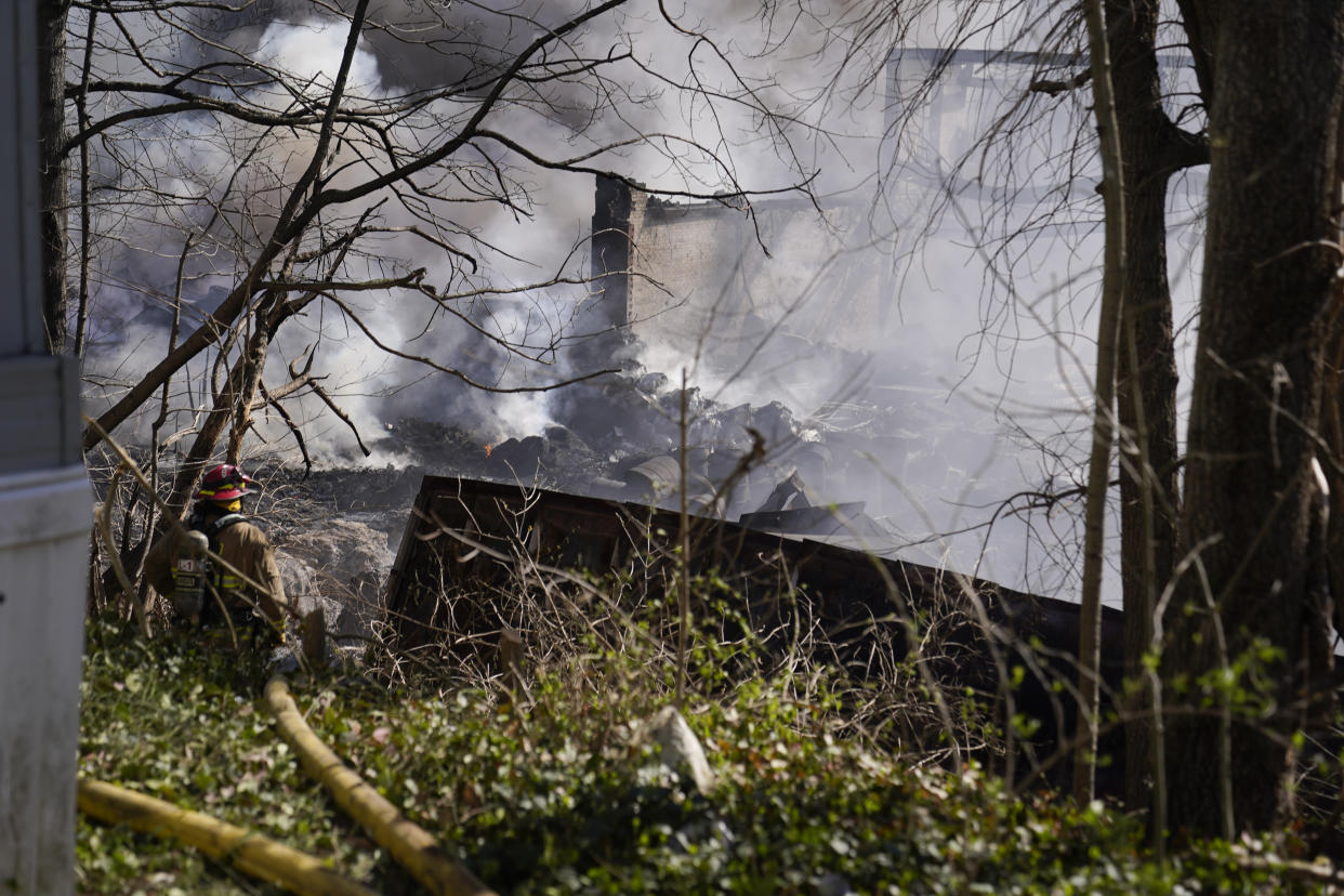 Firefighters continue to pour water on an industrial fire in Richmond, Ind.