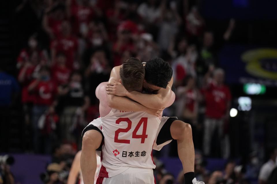 Japan center Josh Hawkinson (24) and Japan guard Yuki Kawamura (5) celebrate after defeating Finland in the Basketball World Cup group E match in Okinawa, southern Japan, Sunday, Aug. 27, 2023. (AP Photo/Hiro Komae)