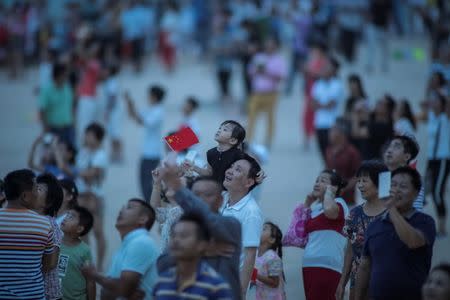 People watch the launch of the Long March-5 Y2 rocket from Wenchang Satellite Launch Center in Wenchang, Hainan Province, China July 2, 2017. REUTERS/Stringer