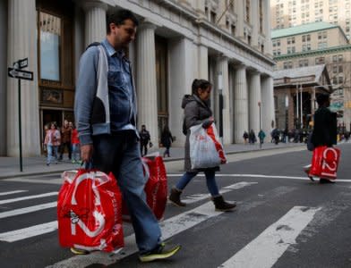 FILE PHOTO - People cross Broadway with shopping bags in Manhattan, New York City, U.S. December 27, 2016. REUTERS/Andrew Kelly