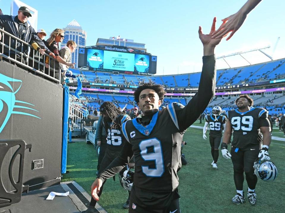Carolina Panthers quarterback Bryce Young reaches up to slap hands with a fan following the team’s 9-0 loss to the Tampa Bay Buccaneers at Bank of America Stadium in Charlotte, NC on Sunday, January 7, 2024.