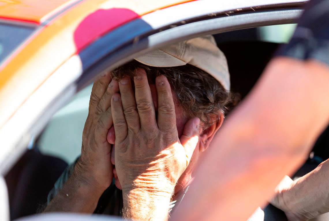 Billy Dutko, 67, left, is consoled by Mike Romeo, 53, in their neighborhood of St. Jude Harbors in Pine Island on Friday, Sept. 30, 2022, in St. James City, Florida. Hurricane Ian made landfall on the coast of Southwest Florida as a Category 4 storm on Sept. 28, claiming lives, destroying buildings and leaving flooded streets, downed trees and scattered debris.